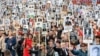 RUSSIA -- People carry portraits of people, including Red Army soldiers as they take part in the Immortal Regiment march on the Victory Day parade, which marks the anniversary of the victory over Nazi Germany in World War Two, in Vladivostok, Russia May 9